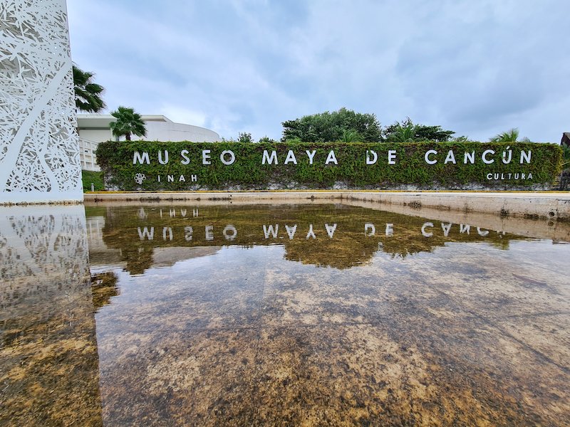 Mayan museum in Cancun with sign for the entryway with a reflecting pool