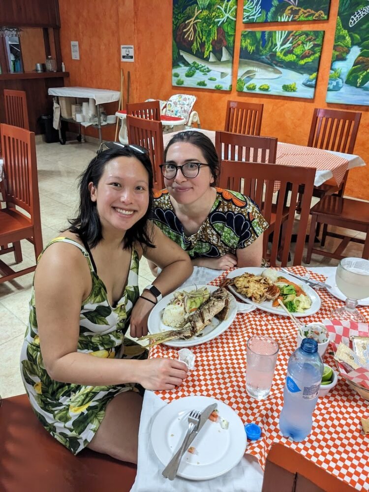 Allison and her partner eating seafood -- fried fish and lobster -- at a restaurant in Cozumel