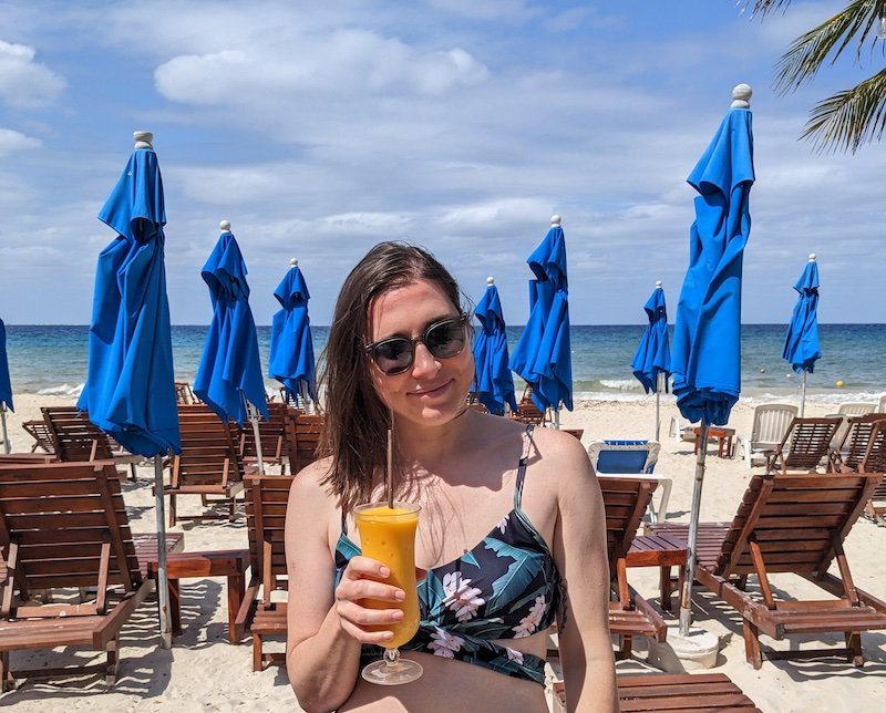 Allison drinking at a beach club on the west side of Cozumel