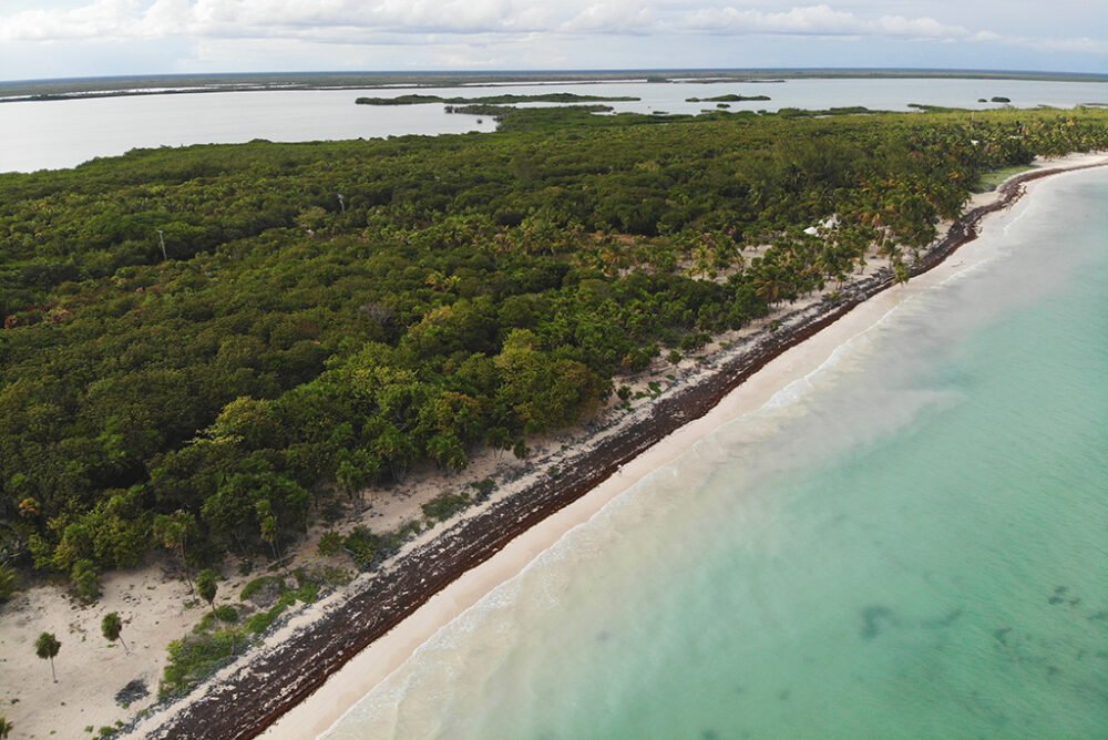 View of the crystal clear waters on the coast of the Sian Ka'an bioreserve and interior dense with lagoons and jungle