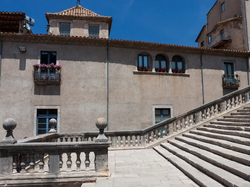 Stone steps and walkways in Girona with old town views and windows with flower boxes