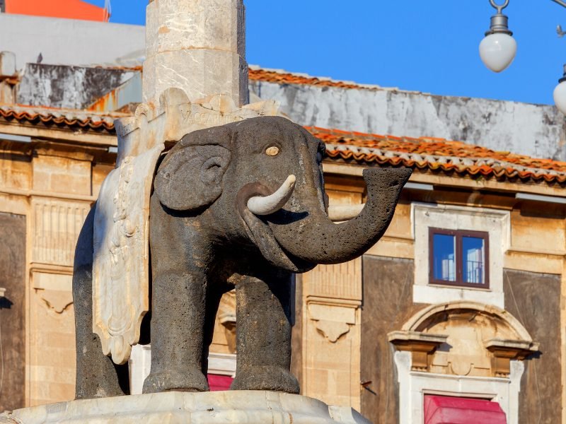 Old ancient elephant statue on a fountain in the center of Catania's main plaza. The elephant is a symbol of the city.