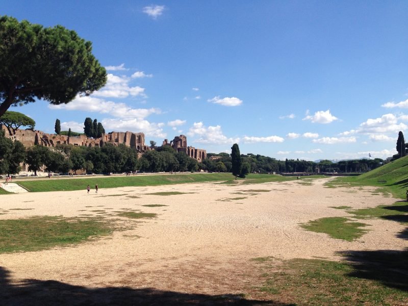 Ruins of brick buildings on the outskirts of the former Circus Maximus, now an empty field, where chariot races and games were once held