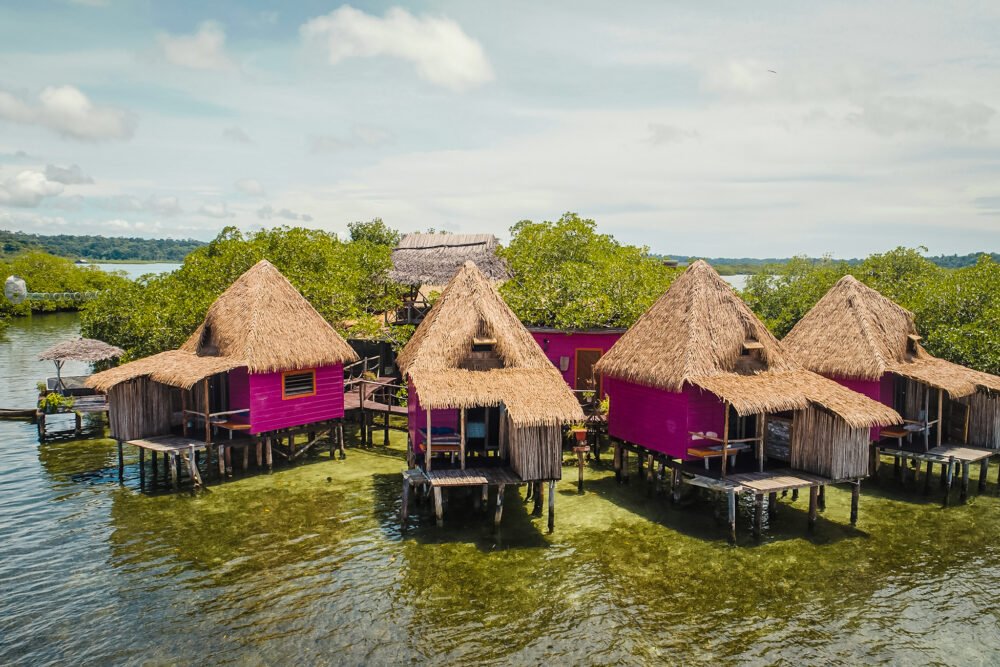 view of the magenta colorful panama overwater bungalows in urraca resort