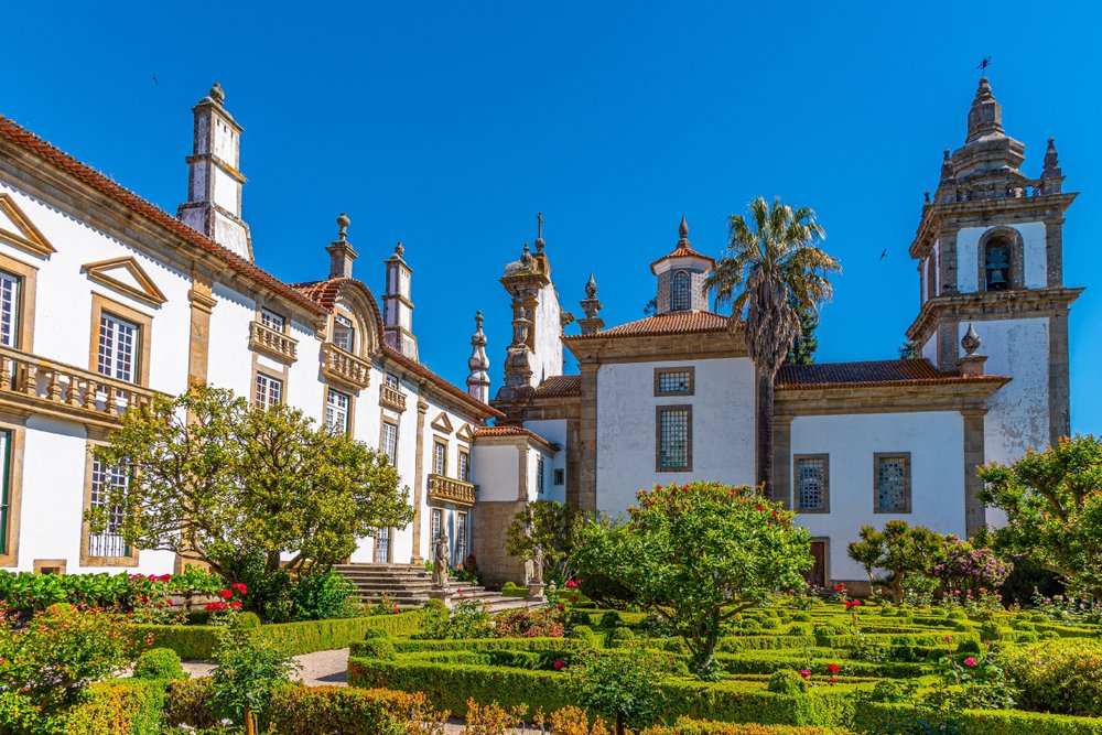 The gardens and white facade of the fancy casa de mateus, an old estate from the 18th century in the Douro Valley.