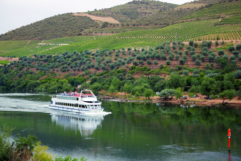 Cruise ship at Foz do Tua, Douro Valley, Portugal, with the Port wine vineyards in the background