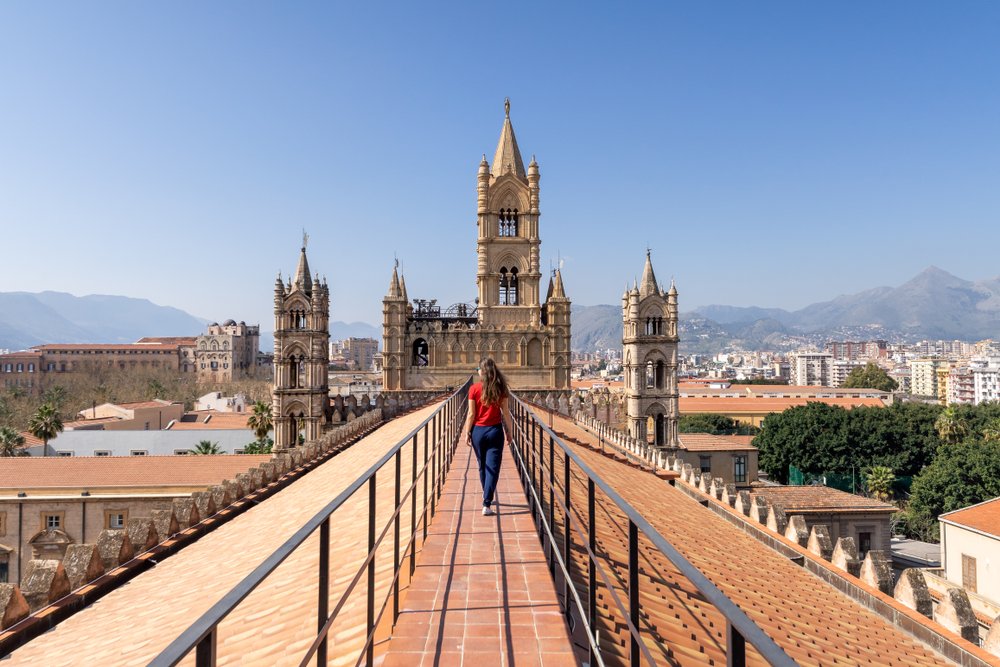 Woman walking on the cathedral roof of the Palermo cathedral in the city center of Palermo