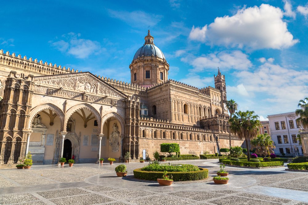 Alternate angle of the Palermo Duomo with gardens and archway entrance in front