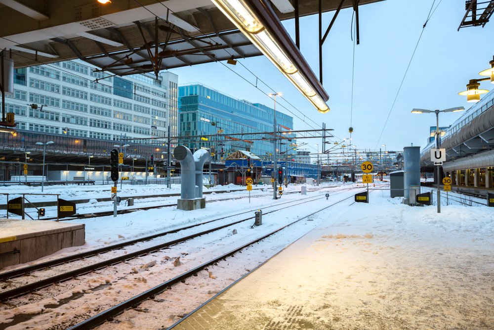 Stockholm Central Train Station platform in winter Sweden with snow on the ground and a cloudy sky