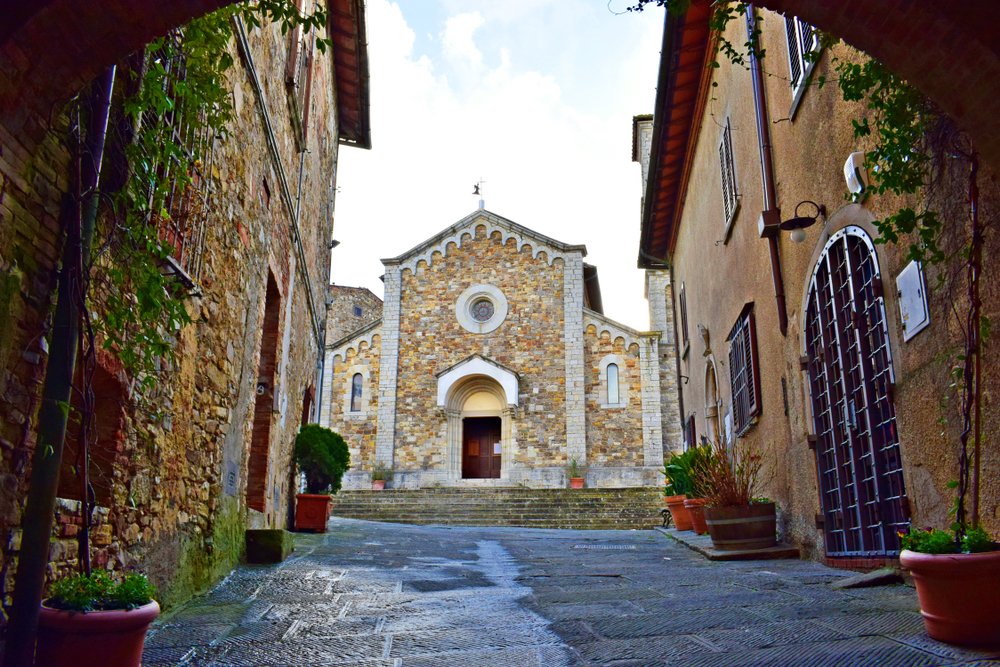 The stone facade of the Church of San Salvatore in neo-Romanesque architecture style, located in the heart of Castellina in Chianti in Tuscany