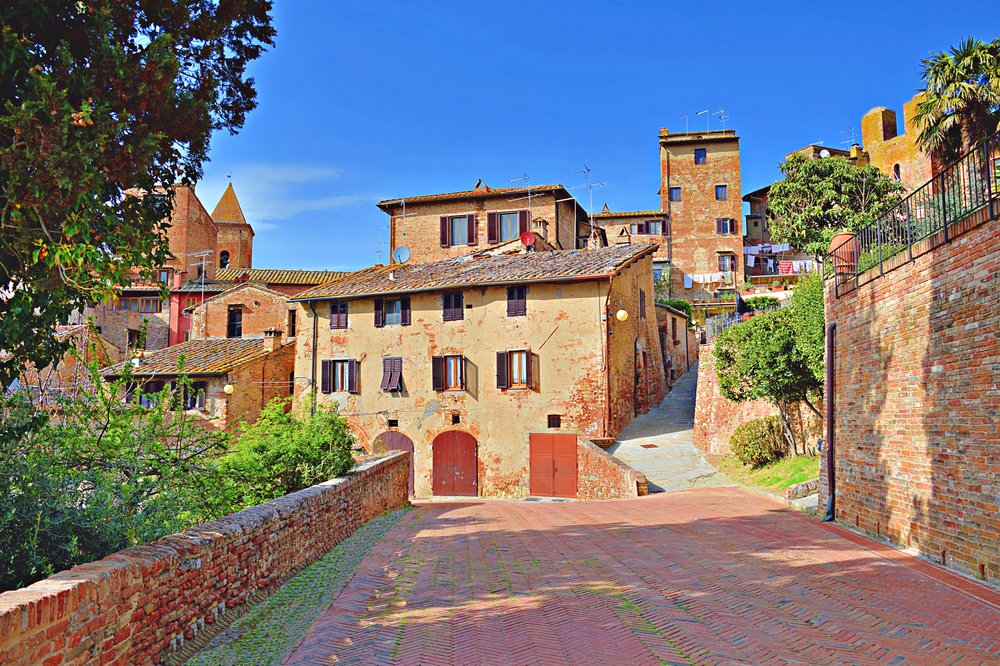 Tuscan medieval village of Certaldo Alto in the province of Tuscany, with orange buildings and brick road and historic towers