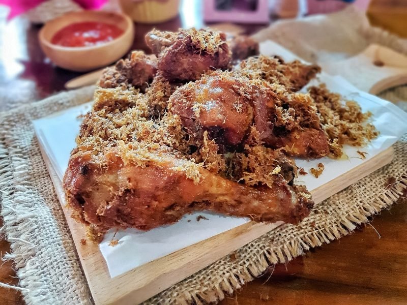 Balinese styled fried chicken with a delicious fried topping on top and sauce in the back