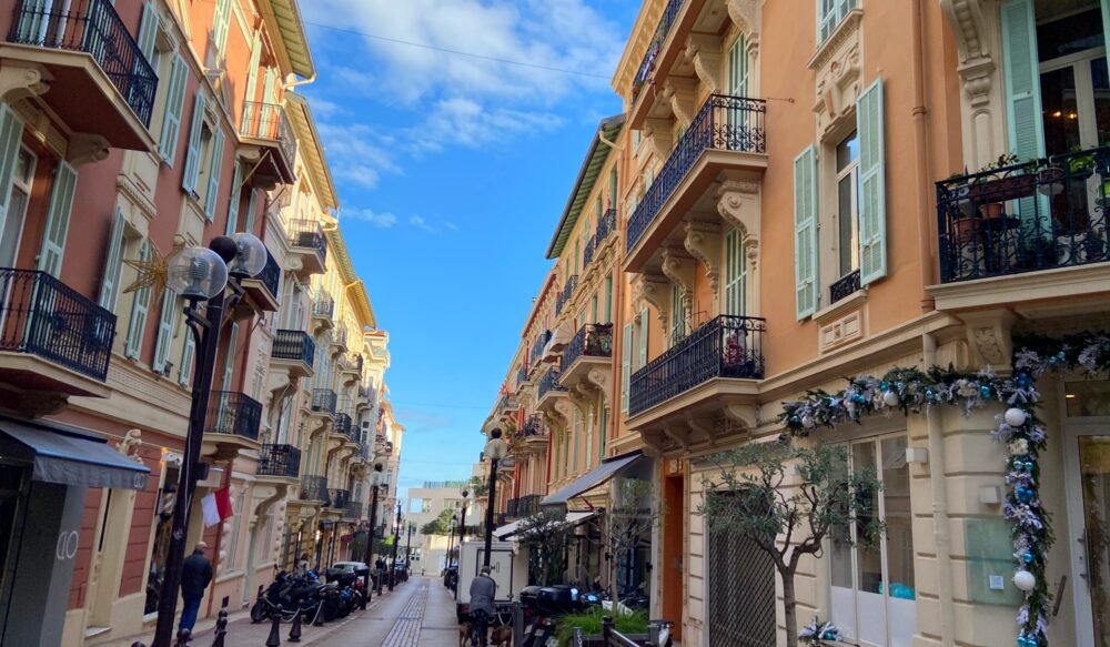 Old town street in Monaco dressed up with Christmas decorations in the winter time