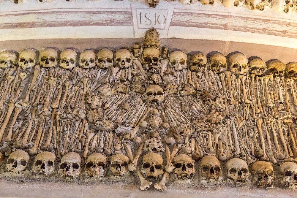 Capela dos Ossos (Chapel of Bones) in Evora, Portugal with skulls, leg and arm bones, creating a visual mosaic that is both disturbing and beautiful
