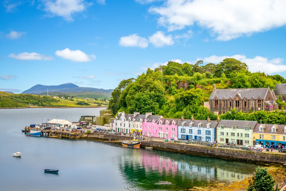 landscape of the Portree harbor on the isle of skye with beautiful pink, blue, green pastel colored houses on the waterfront