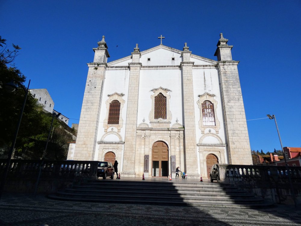 Our Lady of the Immaculate Conception Cathedral, also called Leiria Cathedral, a white church with a few people in front