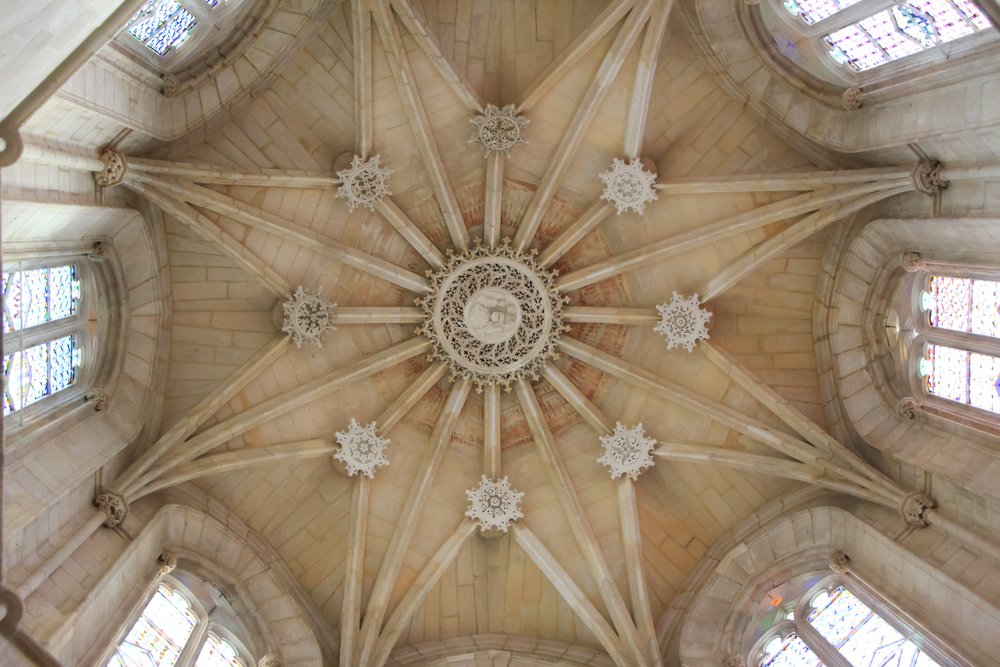 Monastery of Batalha (Mosteiro da Batalha) ceiling inside with a star-shaped pattern of beams and stained glass windows