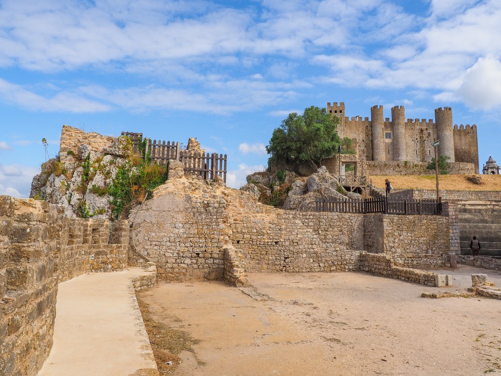 Stone masonry Castle of Obidos and wall ruins or Castelo de Óbidos is a well-preserved medieval castle, with taupe stone brick construction