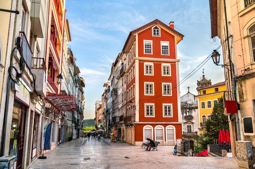 Red building and yellow building in the old town of Coimbra