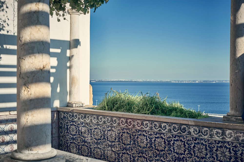 Blue and white tiles with a view over the Tagus river at an overlook called a miradouro