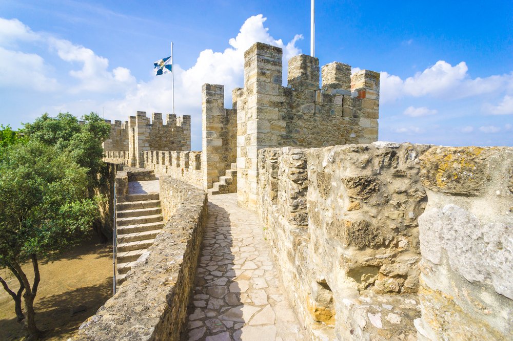 ramparts of the castle sao jorge in lisbon, with stairs leading up to the castle walls, where you can look out at views of lisbon from the top of the city