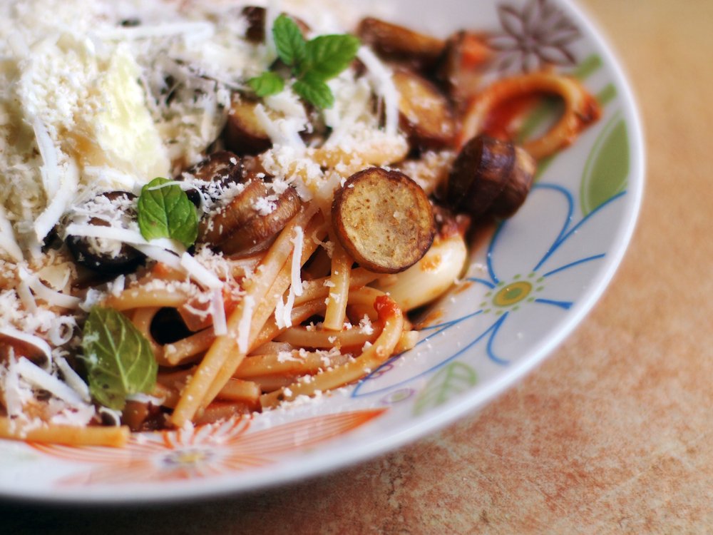 Spaghetti pasta alla Norma, with tomato sauce, fried eggplant, salted ricota cheese, basil, garlic, mint.