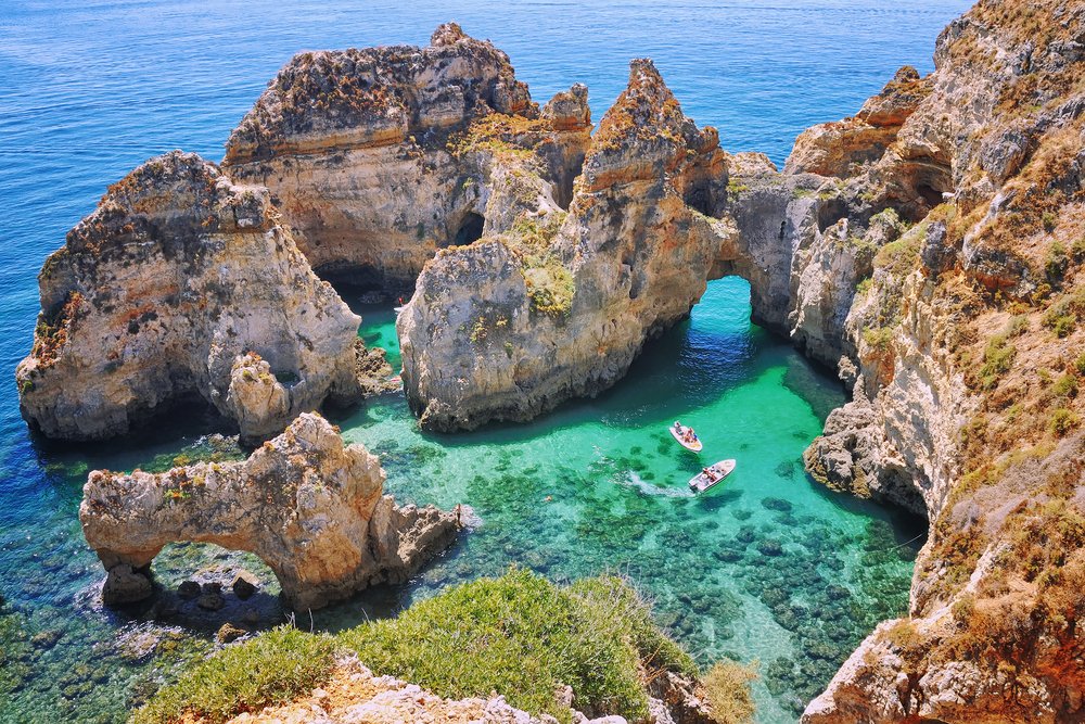 crystalline blue waters of the rock formations around ponta de piedade