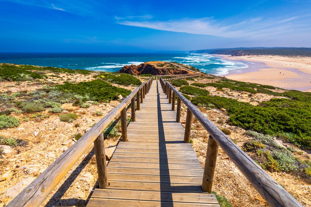 Boardwalk at Praia da Bordeira with a stunning ocean view as you walk along the boardwalk on Portugal's southern coast on a sunny day