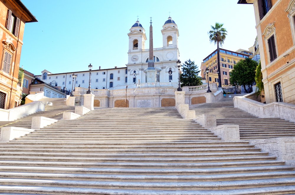 The famous 'Spanish steps' of Rome which have a long row of stairs that then leads up to a obelisk and church