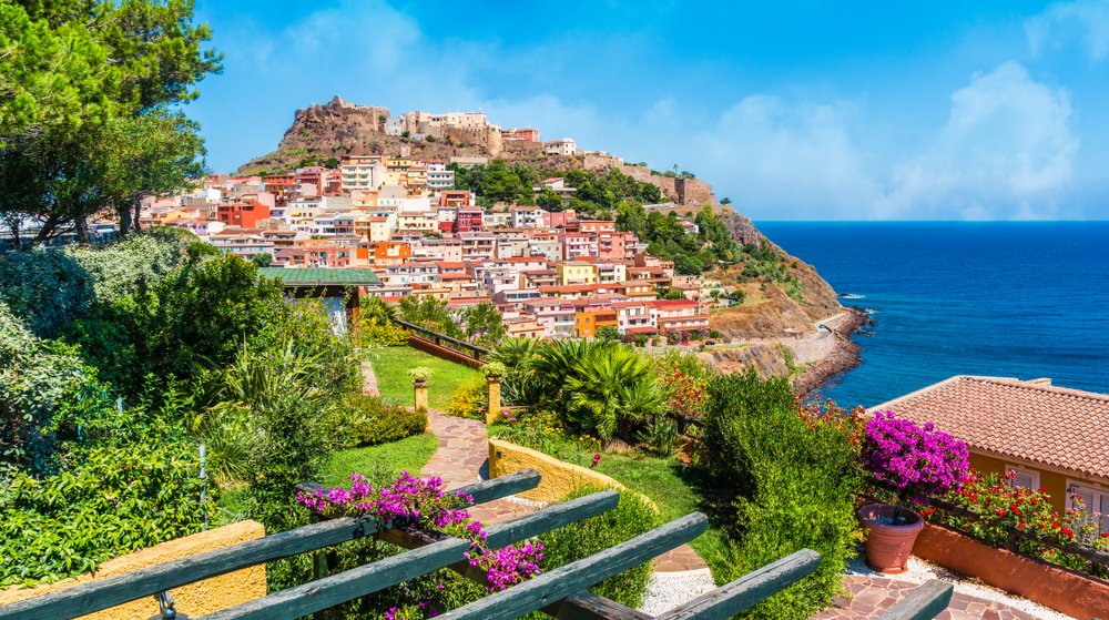 Medieval town of Castelsardo, as seen from a garden with a view overlooking all the town, with colorful buildings on the seaside