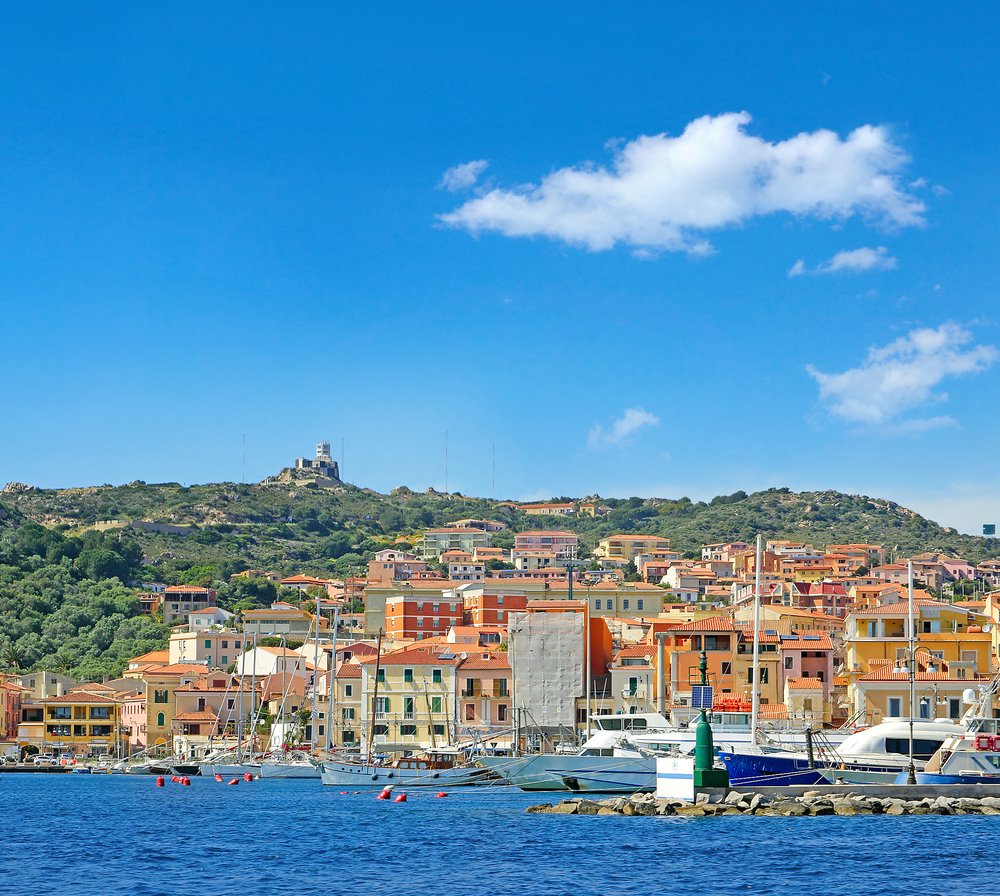 The seaside town of La Maddalena located on the island with the same name, with boats and colorful buildings and marina