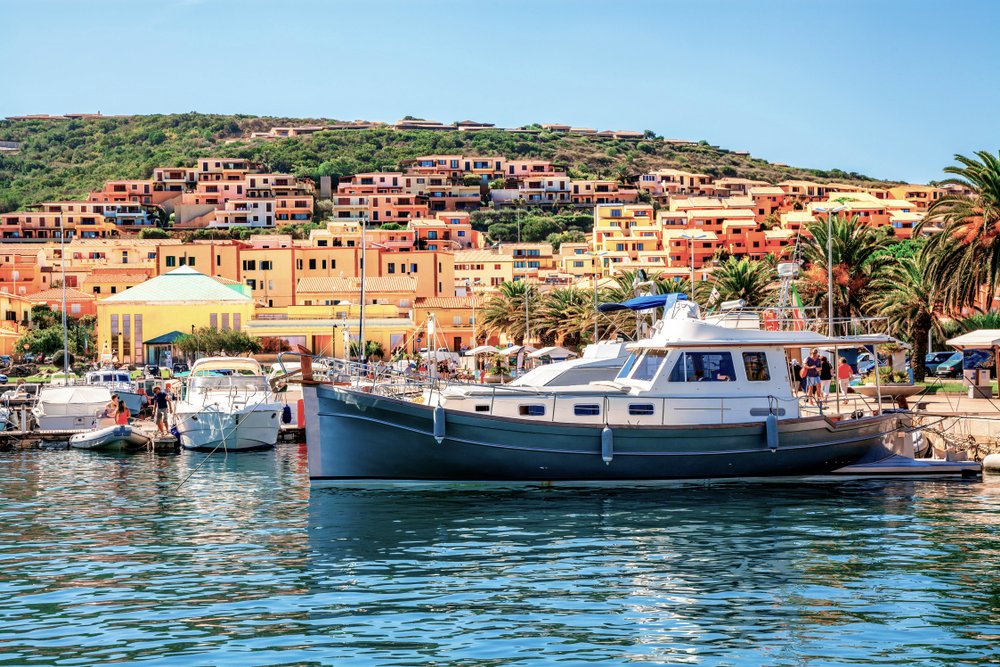 Beautiful bay with ships in Palau, Sardinia, Italy and the colorful architecture of the houses of Palau.