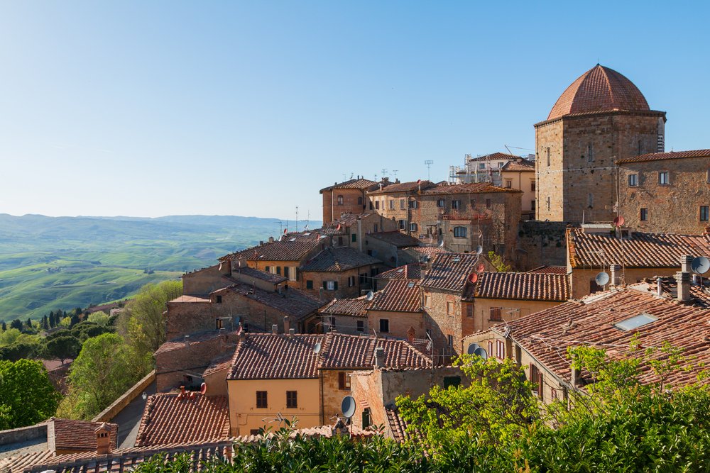 The stone walls and terra cotta roofs of Volterra Italy, in the Tuscan countryside, a must-stop on this Tuscany road trip itinerary