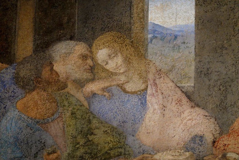 detail of three people that has faded over time in the last supper fresco by da vinci