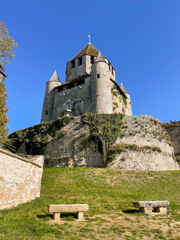 the well preserved medieval caesars tower in provins built upon a stone rampart with a weather vane at the top