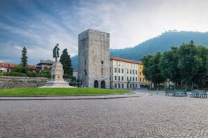 Como city, historic center, lake Como, Italy. Picturesque view, square Vittoria and medieval tower (12th century) called Porta Torre.