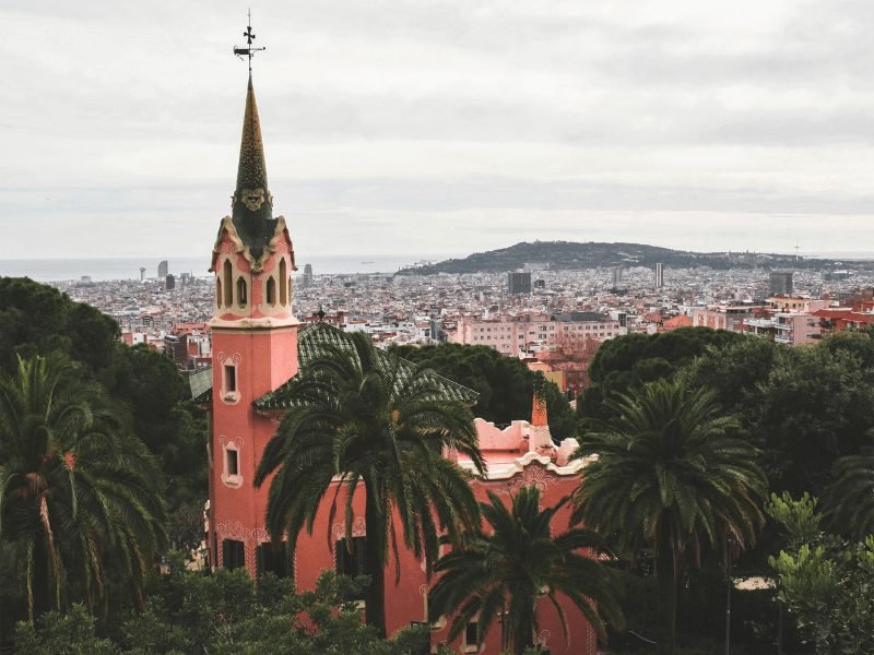 the gaudi house museum in the park guell complex area, a reddish house with a steep tower, high on a hill in Barcelona 