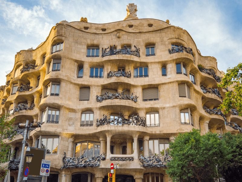 the ornate, undulating wave-y pattern of a gaudi building called casa mila, one of the most beautiful gaudi sites in the city