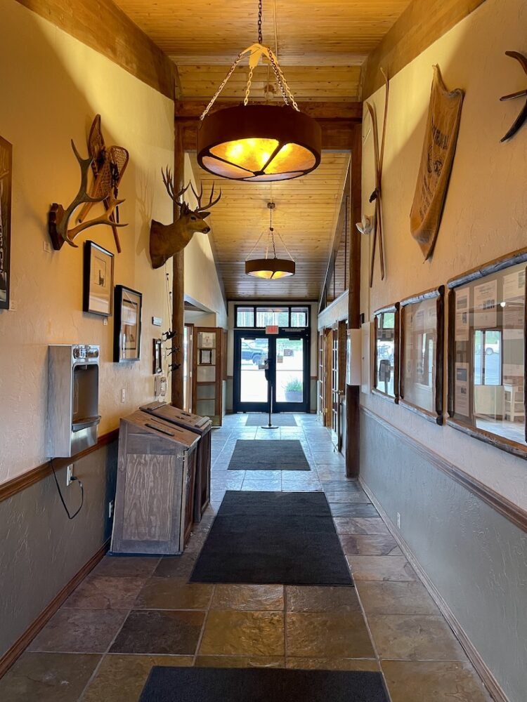 Lodge style furnishings with mounted dear head and cross country skis on the wall at Jackson Lake Lodge, a popular breakfast spot in Grand Teton