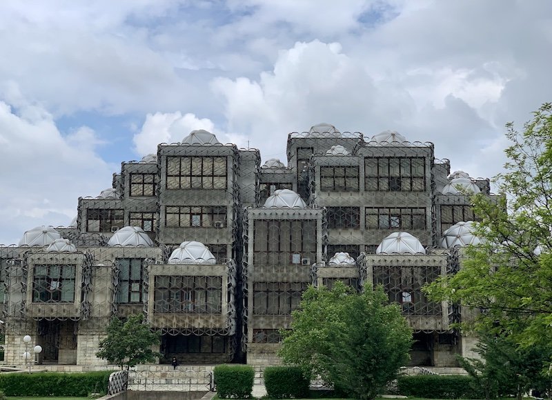 The strange design of the Kosovo Library with bubble domes and what looks like barbed wire surrounding the entire building