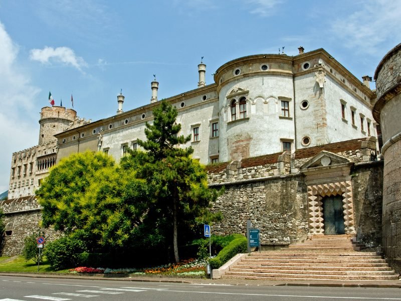 Trento castle Buonconsiglio Castle, a historic fortress castle in the city with beautiful detailing and plants in front and stairs