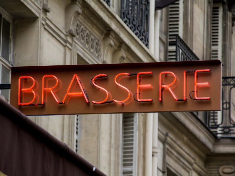 simple red neon sign that reads 'brasserie' which means a nice lunch spot 