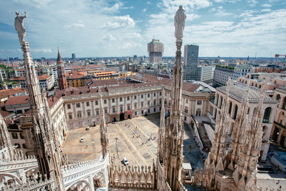 A view from the duomo terrace on a sunny day in the city of Milan, views over the square, spires, and the rest of the milan cityscape