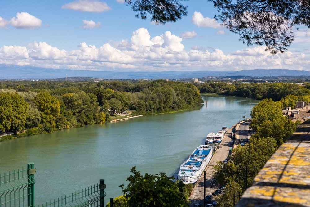 View of the Rhone River and the barges at the quay from the Jardin des Doms in Avignon