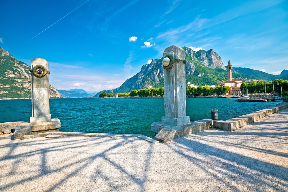 Town of Lecco on Como Lake waterfront and church view on a brilliant sunny day