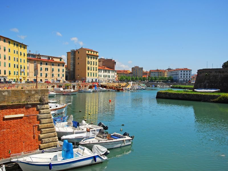 waters in livorno harbor with boats, buildings on the seafront