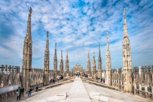The terraces of the milan duomo with brilliant blue sky with some patchy clouds