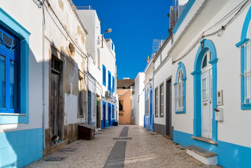 the town of olhao in portugal with whitewashed houses and pretty colors