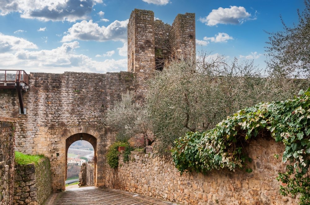 Fortified walls of the small town of Monteriggioni, with ivy and trees