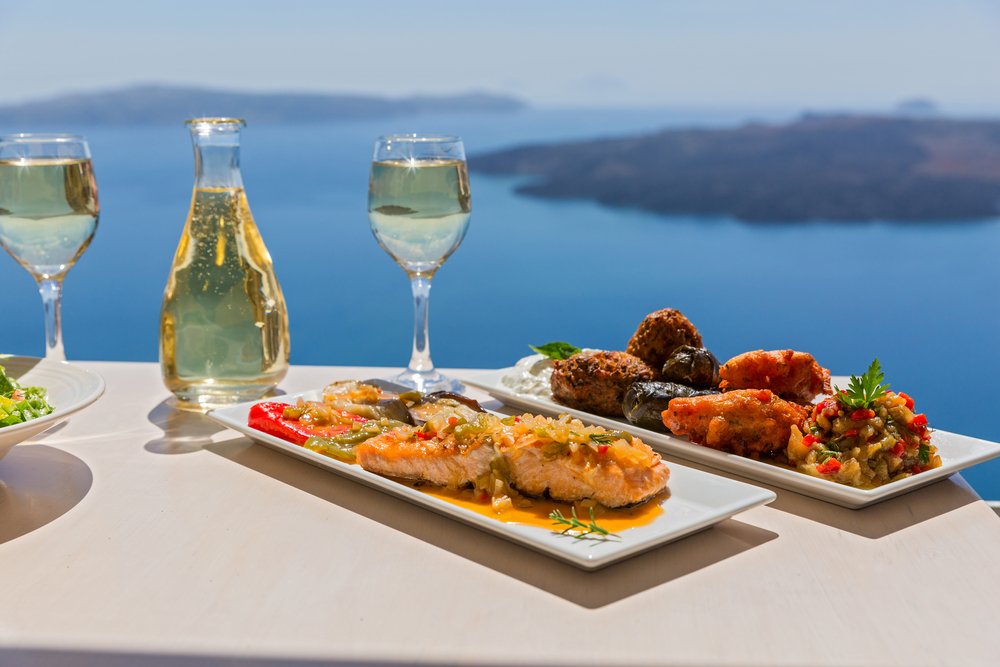 Santorini white wines with some greek food to eat and nibble on sitting on the edge of a sea-view restaurant on the caldera of Santorini